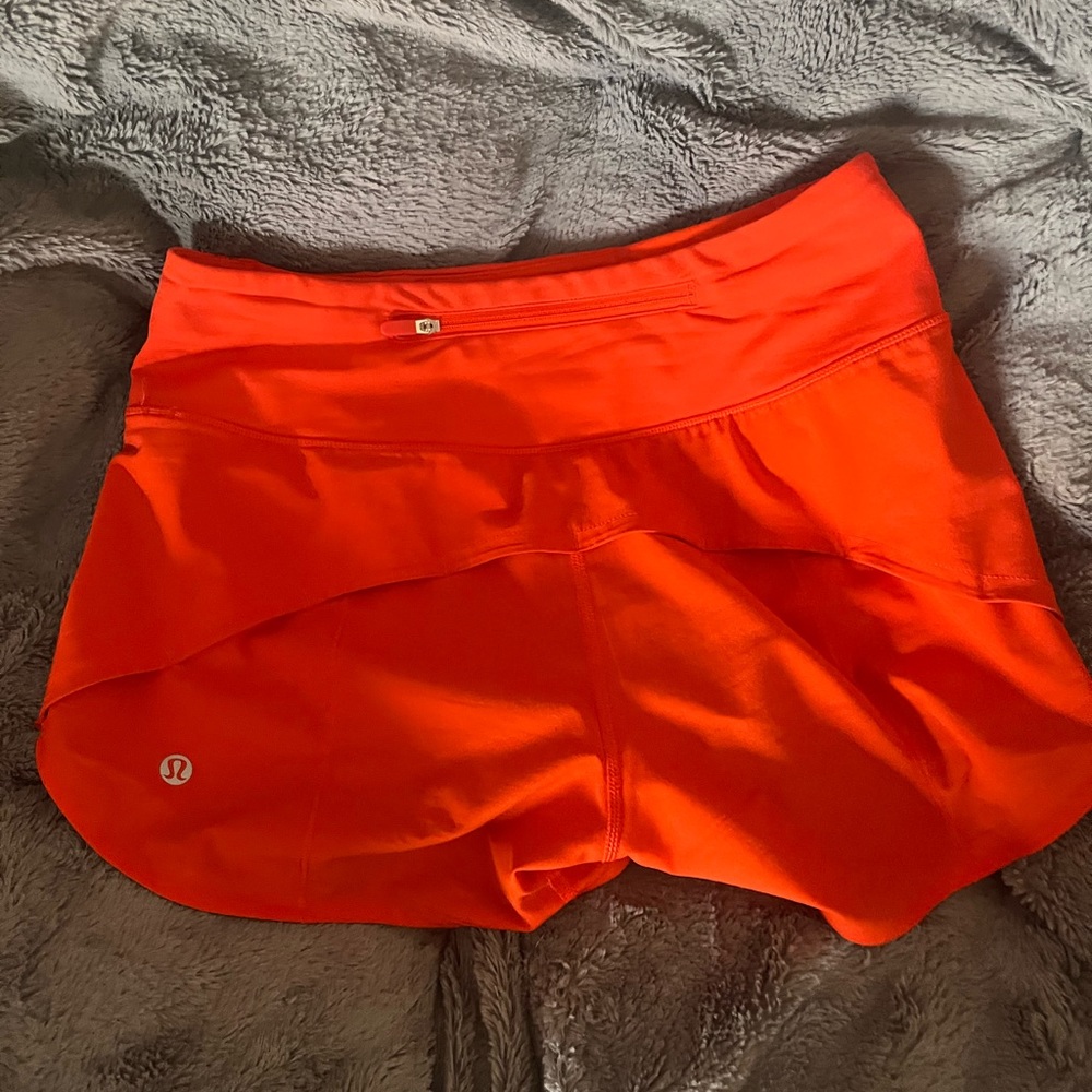 Orange Lululemon Speed up shorts. Mid rise 4” size 2! Rare color no longer sold.
